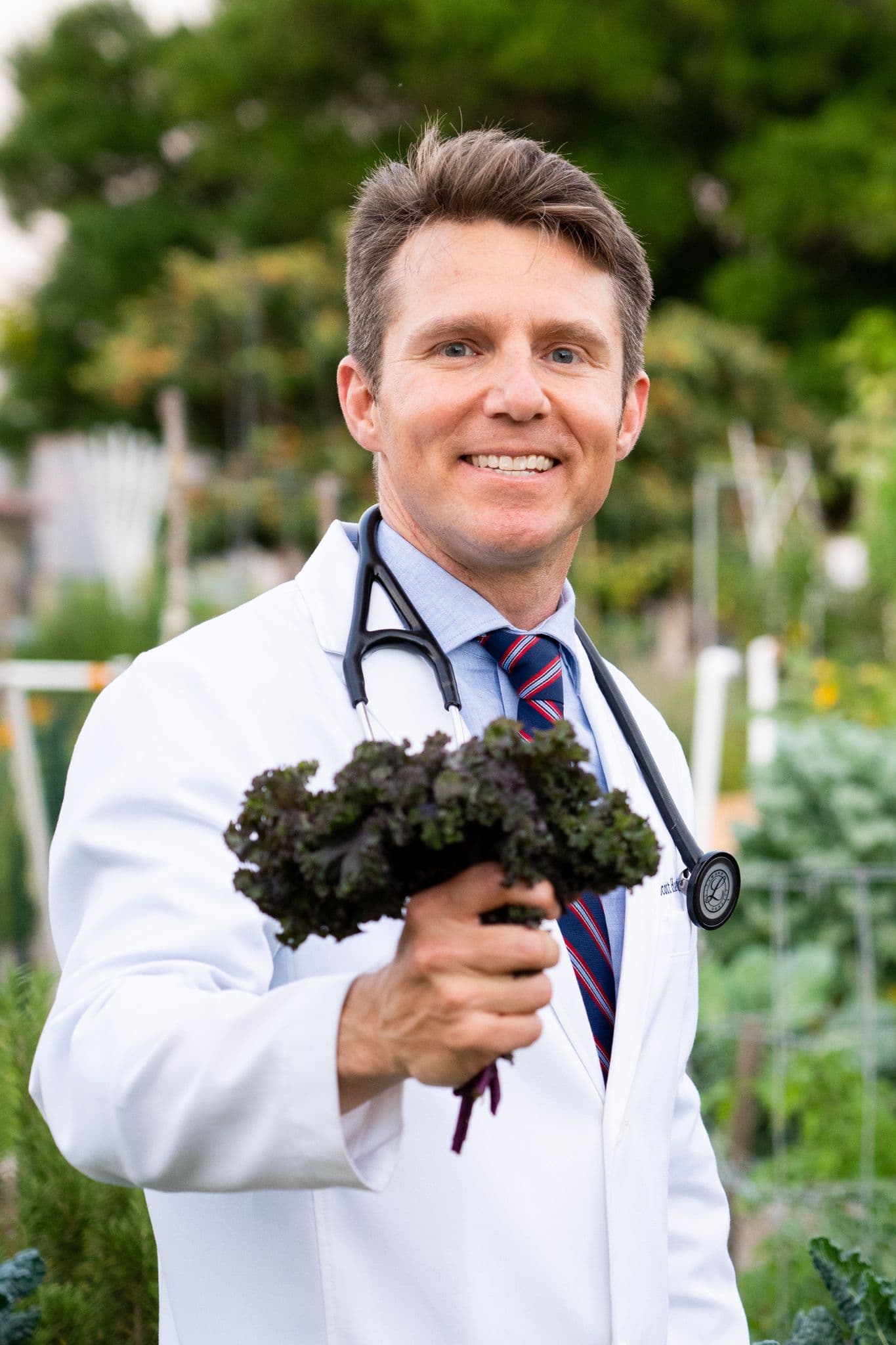 Dr. Scott Harrington holding freshly harvested kale